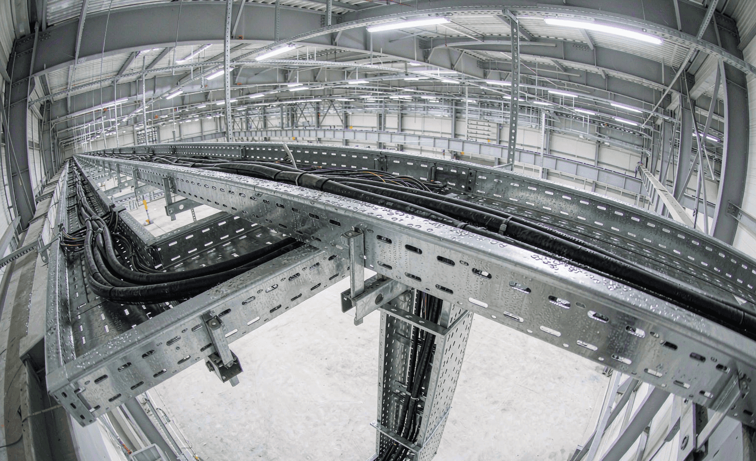 Cable trays routing power cables in an industrial facility